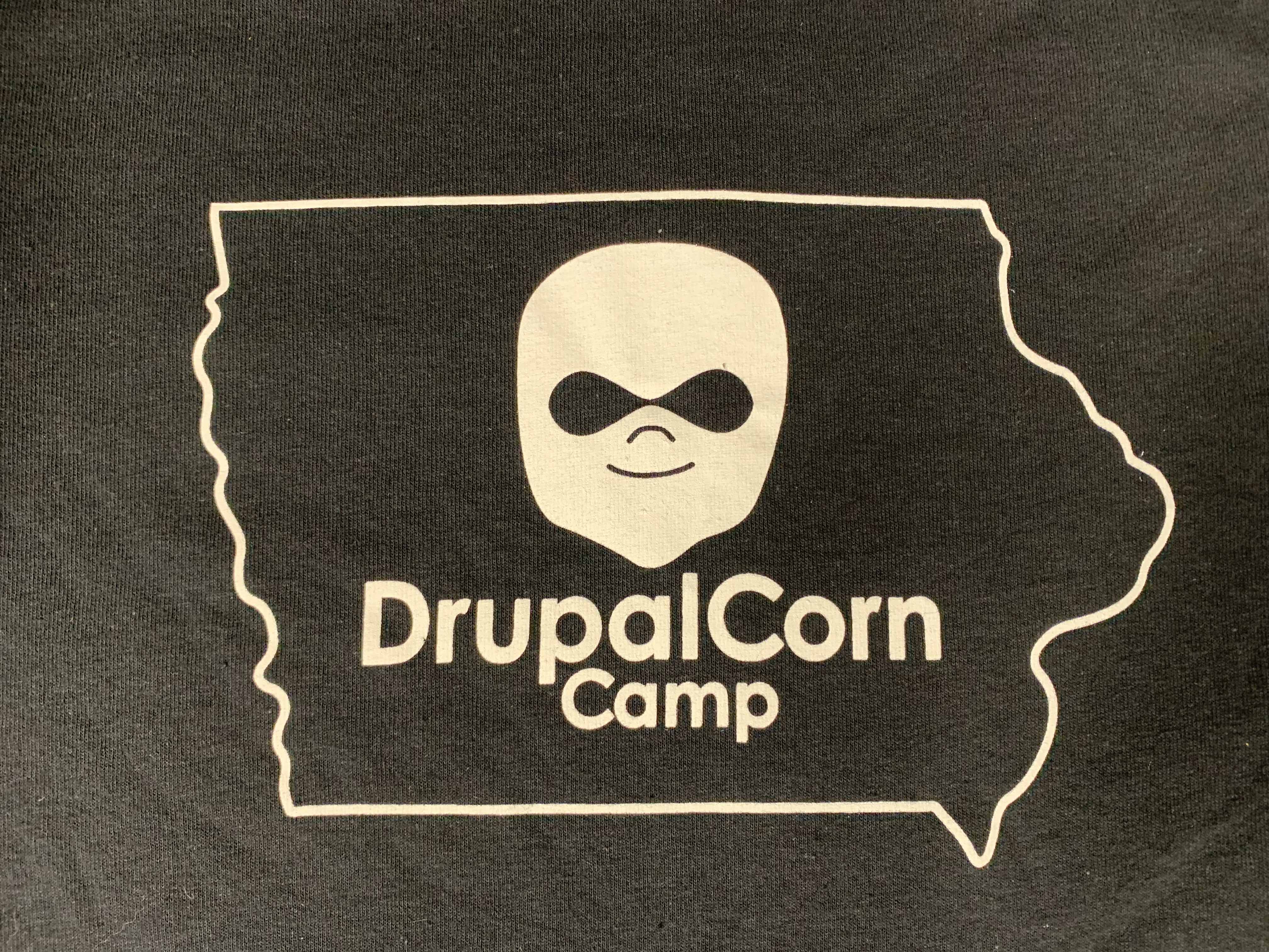 2019 DrupalCorn Shirt - Black with White lines. Outline of the state of Iowa with DrupalCorn Logo in the middle and text 'DrupalCorn'